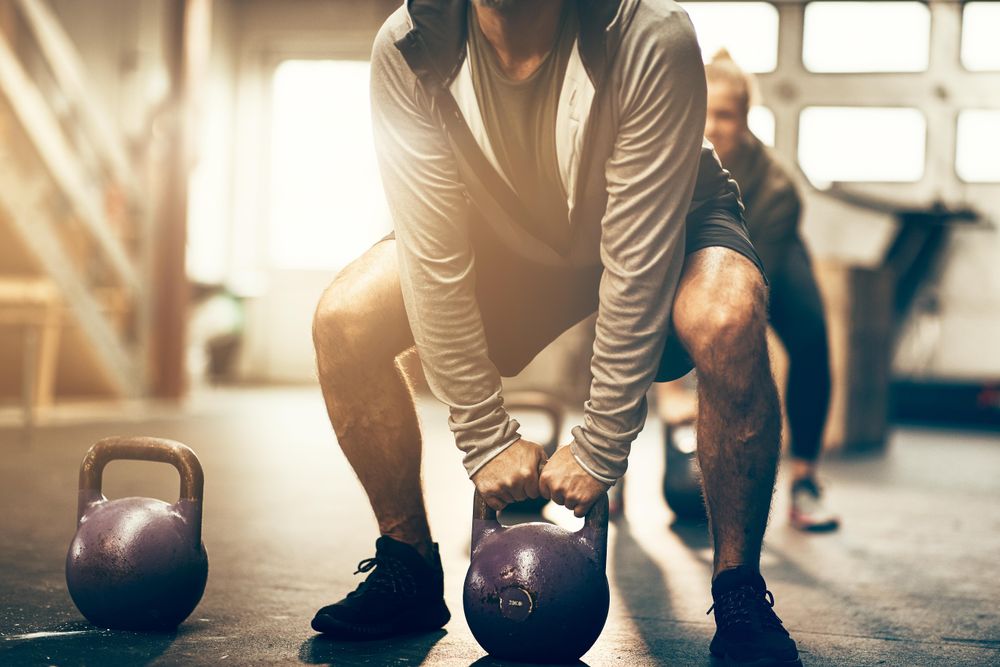 Man performing squat with kettlebell