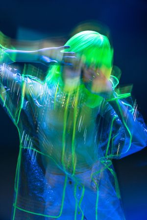 Asian woman posing in fluorescent light