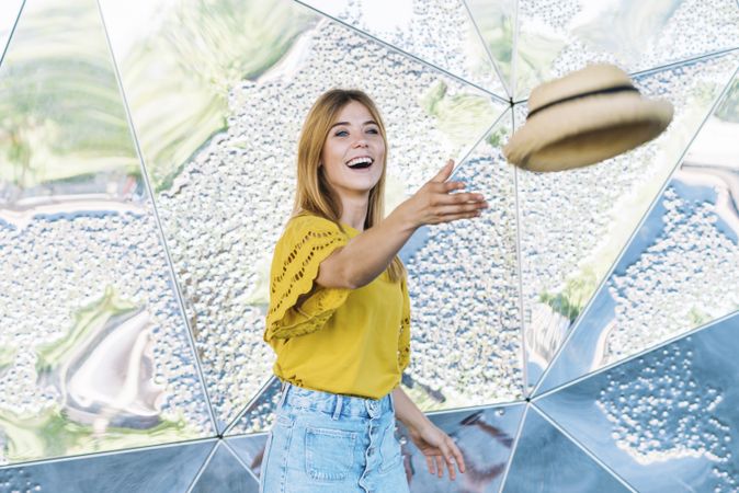 Woman throwing hat into air