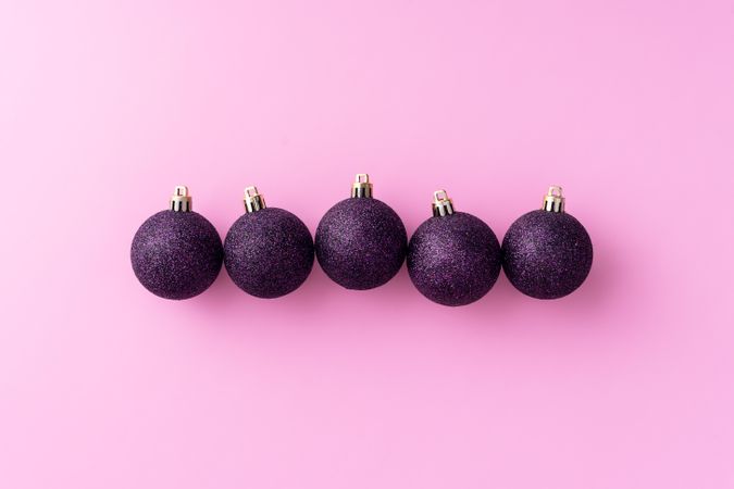 Purple Christmas baubles in a single row