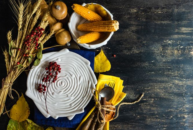 Top view of textured porcelain birds plate with rustic autumnal decor, copy space