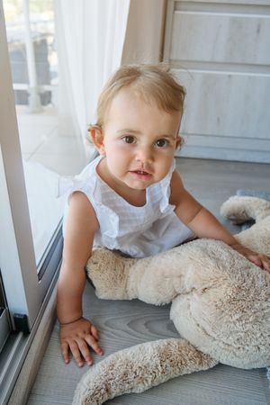 Cute little girl playing with toy at home