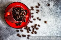 Top view of red cup full of coffee beans 0v9wgb