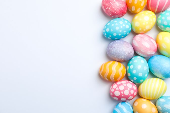 Decorative Easter eggs on neutral background, space for text. Top view