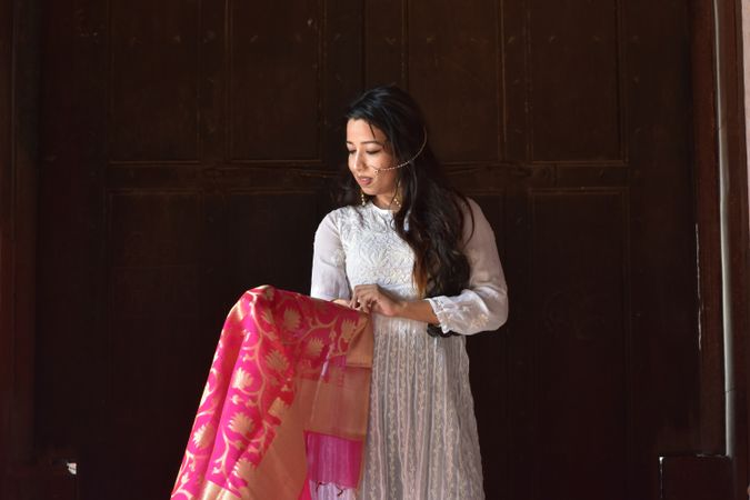 Woman in light dress looking at her sari