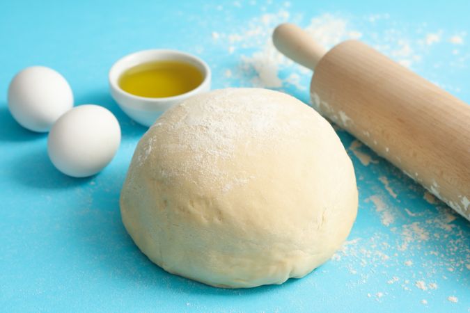Concept for baking with dough on blue background