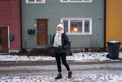 Cheerful female against northern house