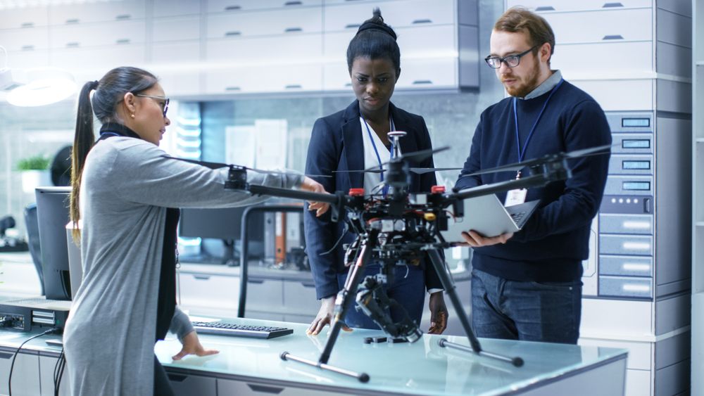 Multi Ethnic Team of Young Female and Male Engineers Working on Modern Drone Prototype.