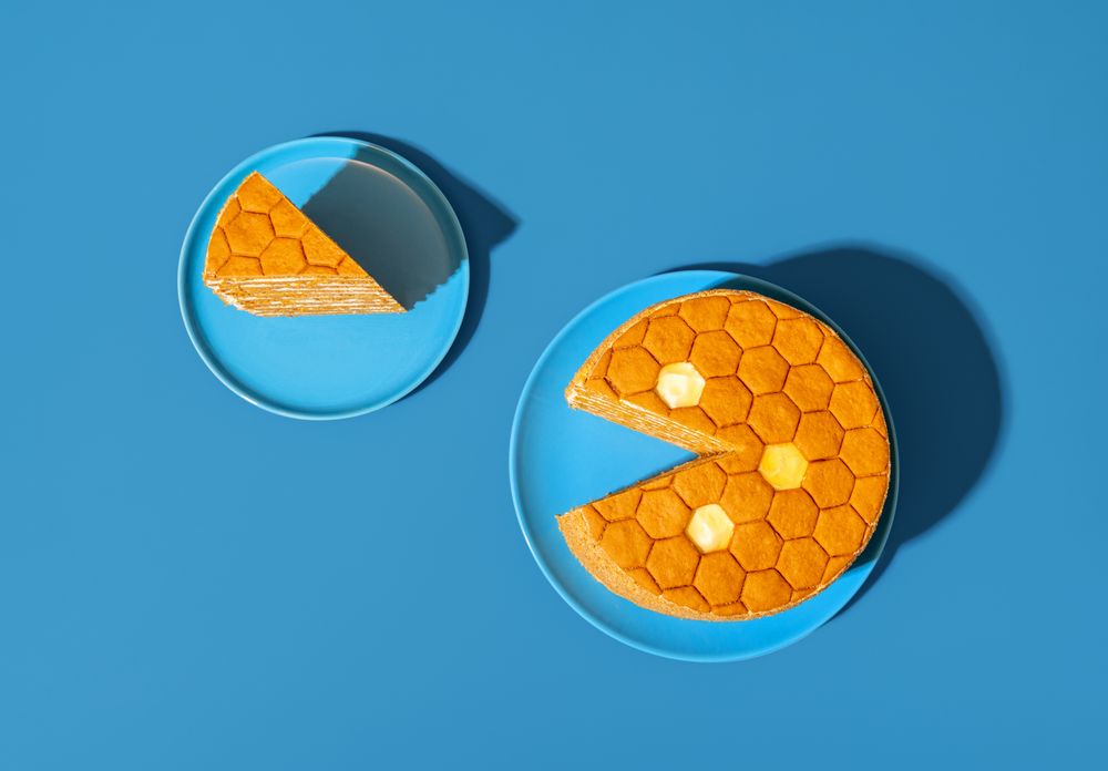 Homemade honey layered cake, in bright light minimalist on a blue table