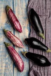 Ripe eggplants on shabby tabletop