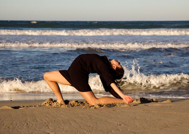 Woman with dancing near water on shore