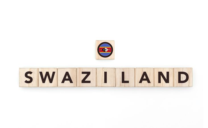 Wooden blocks bearing the name and flag of Swaziland. Swazi and South African Culture, national identity, travel, and geography in a copy space design.