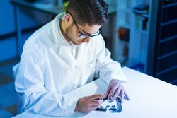 Young man repairing modern device