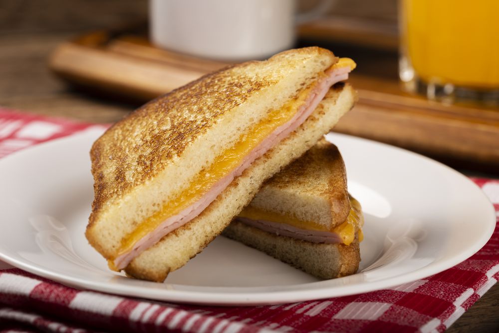 Grilled ham and cheese. Sandwich with cheese and ham on grill.