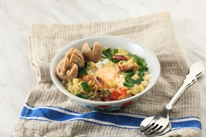 Indomie Rebus or Instant Boiled Noodle with Bakso and Boiled Egg