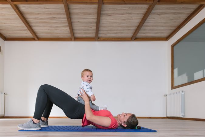 Mother exercising with baby in gym