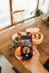 Photographer taking picture of food with smartphone