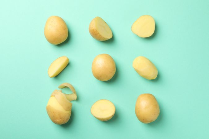 Potatoes cut in different ways in square shape on green background