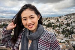 Cheerful woman visiting ancient city