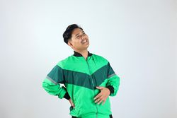 Adult Asian Indonesian Man Touching his Belly with Relieved Expression