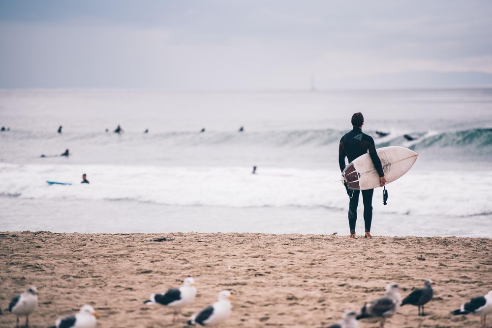 Man holding surfboard at the beach