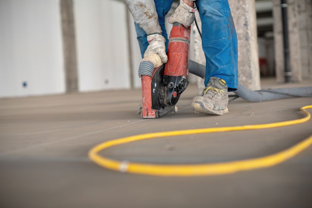 Crop site worker using concrete cutter