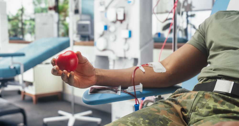Close Up Of Hand Of Black Army Soldier With Attached Catheter In Military Hospital.