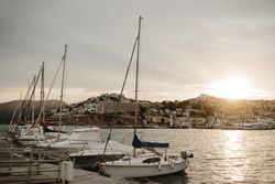 Yachts docked in sea port at sunset