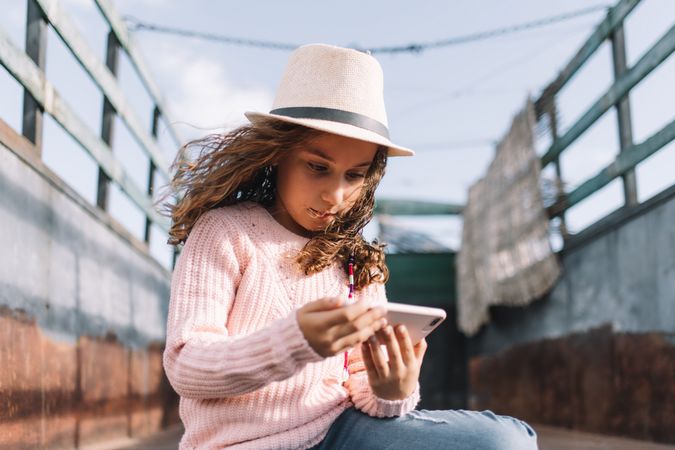 Focused girl using smartphone in countryside
