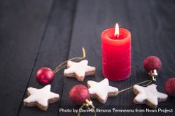Red candle on wooden table and Xmas elements 5qnmJ4