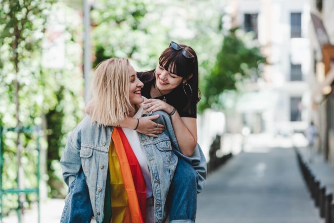 Happy lesbian couple having fun on street