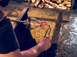 Unrecognizable glassblower making glass vase