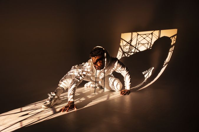 Black man dancing under bright light