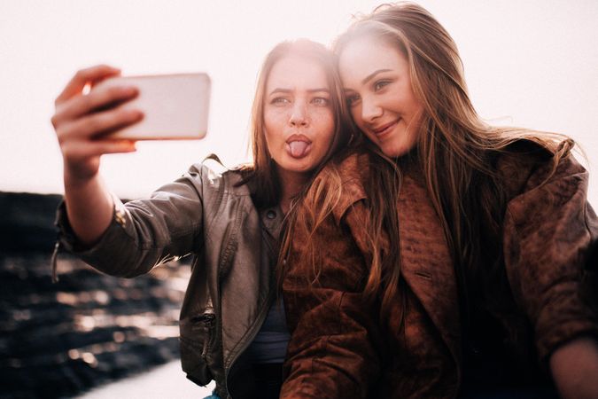 Two young women taking a selfie outside