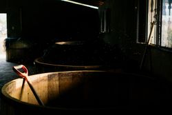 Wooden tanks at dark dusty barn