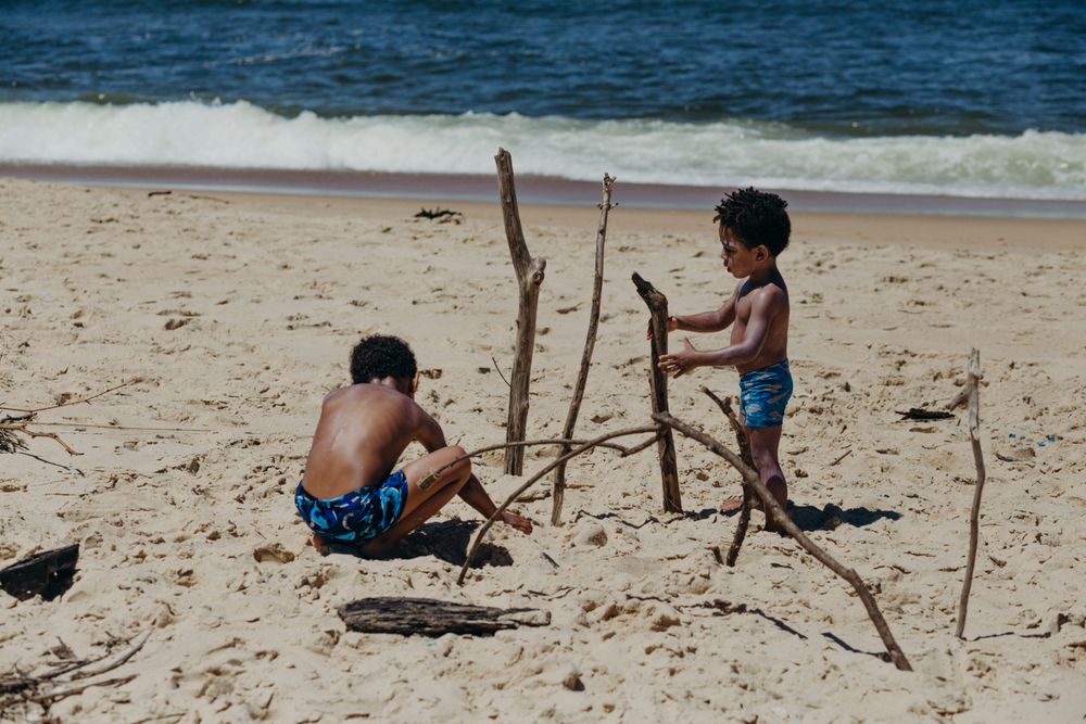 Black boys playing on beach