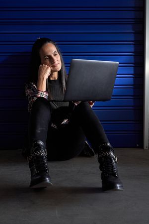 Woman browsing laptop near self storage