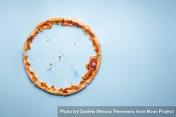 Pizza crust leftovers on blue paper background bD6RE5