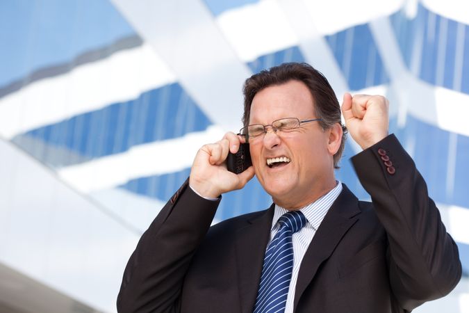Excited Businessman on Cell Phone