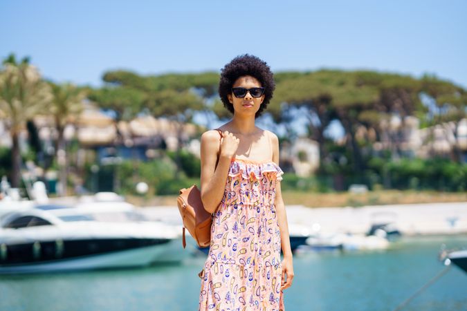 Woman in maxi dress standing on dock