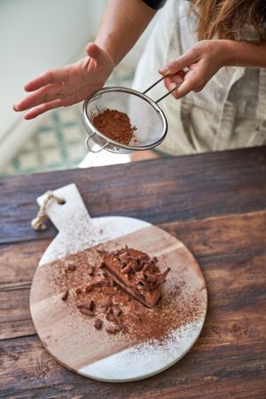 Faceless woman preparing chocolate cake at home
