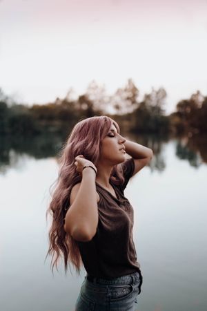 Stylish woman on lake shore