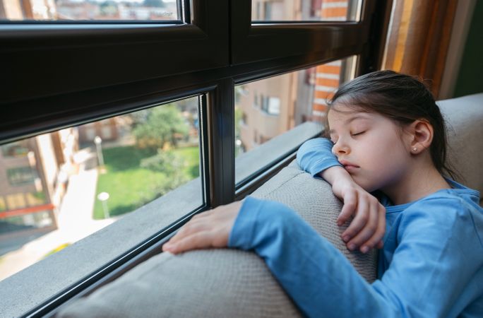 Sad girl looking out the window