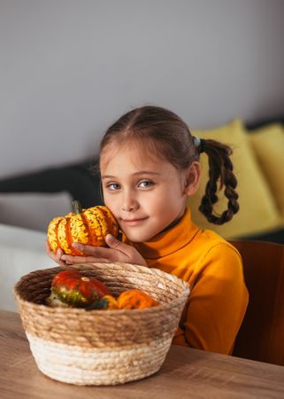 Little Girl Playing With a Pumpkin.