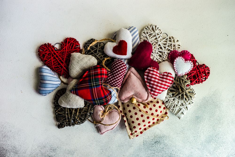 St. Valentines Day concept with top view of felt hearts on marble