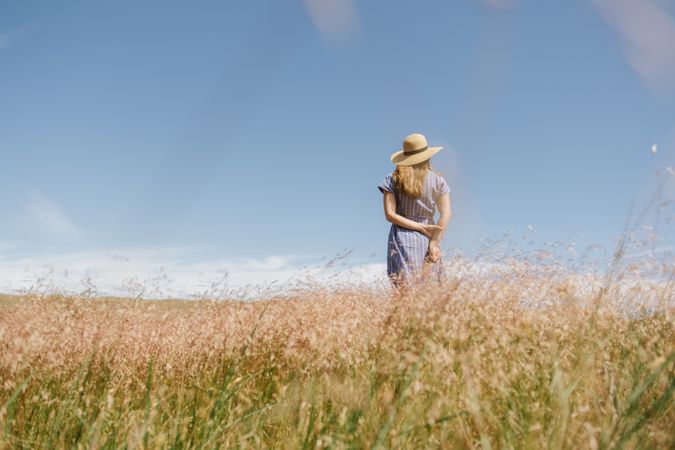 Young woman gathering dried spikes