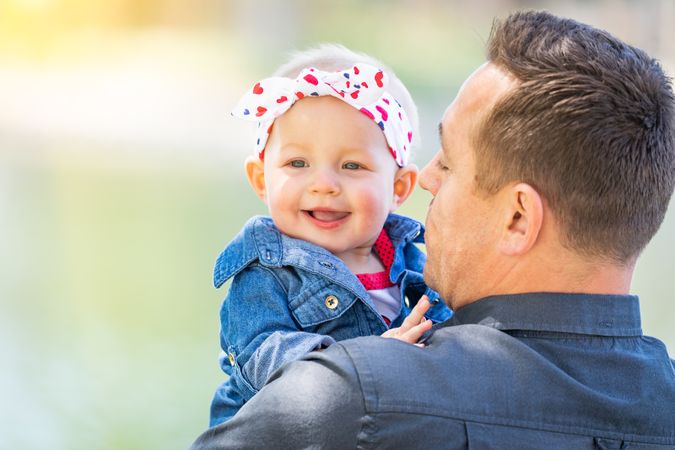 Young Father and Baby Girl At The Park