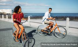 Tourist couple riding around the city on bicycles bxGgv4
