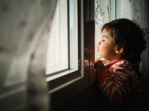 kid peering through window
