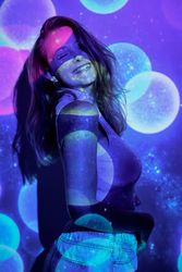 Merry woman dancing under colorful specks